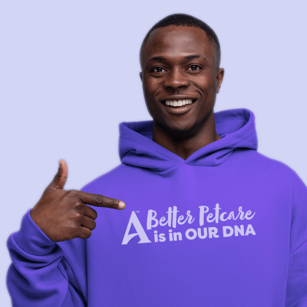 Man in purple sweatshirt pointing to the Antech logo.